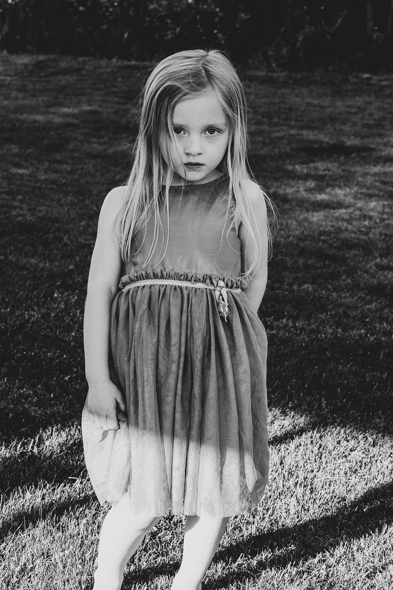 Kylee is registered to the contest to win money with this photo: black_and_white, day_dress, dress, eye, face, flash_photography, grass, hair, hairstyle, happy, head, leg, nature, one_piece_garment, people_in_nature, person, plant, shoulder, standing, style