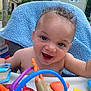 baby, child, smiling, curly_hair, high_chair, toys, colorful, blue_blanket, indoor, happy, face, skin, expression, person, cute, infant, playtime, plastic_toys, mouth_open, background