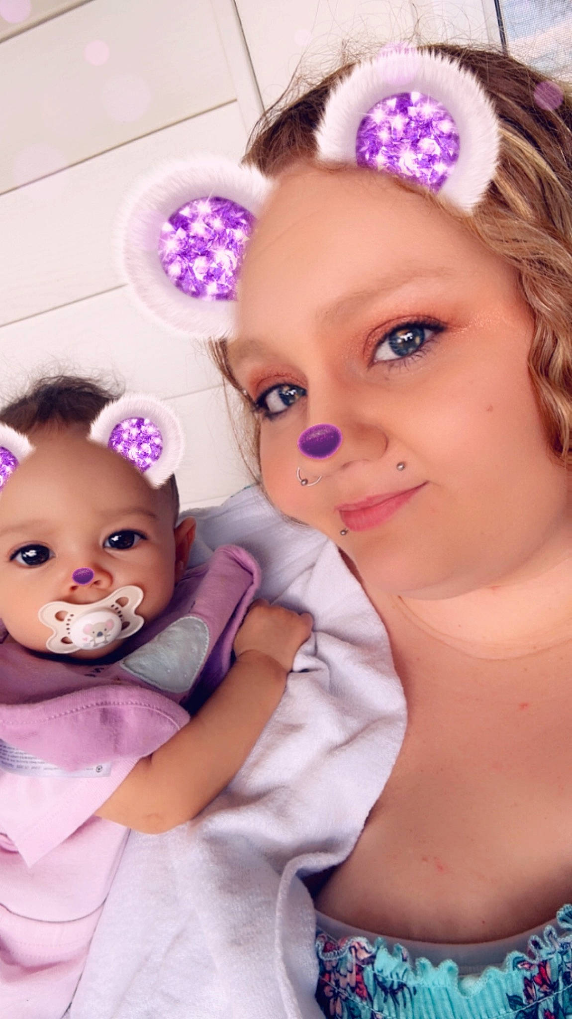 Aiyanna is registered to the contest to win money with this photo: cheek, chin, clothing, dress, ear, eye, eyebrow, eyelash, gesture, hairstyle, happy, head, headgear, iris, organ, person, pink, purple, skin, toy