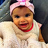 baby, child, smiling, headband, pink_flower, blanket, fluffy, chair, indoor, happy, cute, person, portrait, young_child, cozy, fabric, soft, face, toddler, clothing