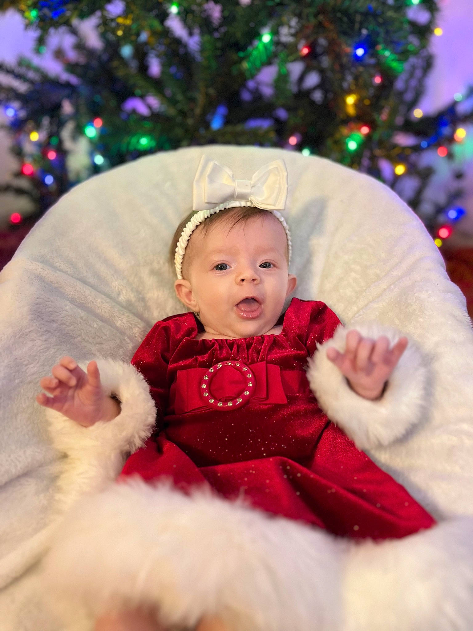 Ava joined the competition — help win amazing prizes! baby, baby_toddler_clothing, beauty, cheek, child, christmas, christmas_decoration, christmas_tree, event, facial_expression, fun, happy, head, holiday, magenta, person, sleeve, standing, toddler, tree