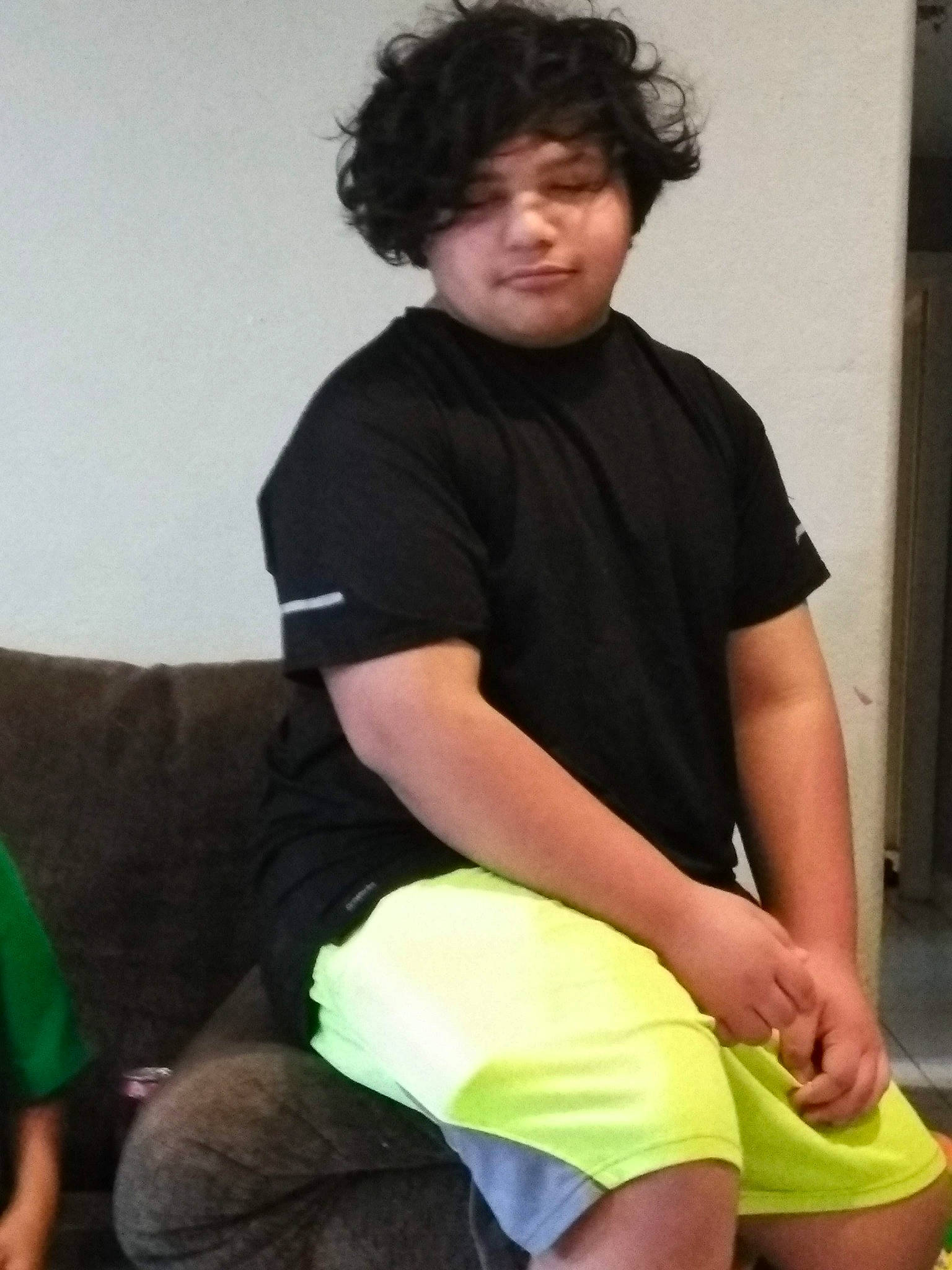 Nicholas is registered to the contest to win money with this photo: arm, elbow, joint, knee, leg, male, neck, person, shoulder, sitting, t_shirt, thigh