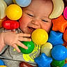 Giovanni is registered to the contest to win money with this photo: baby, child, smiling, playing, colorful_balls, plastic_toys, star_shape, hand, face, happy, infant, toy_ball, playtime, toddler, bright_colors, indoor, casual_clothing, closeup, cute, fun