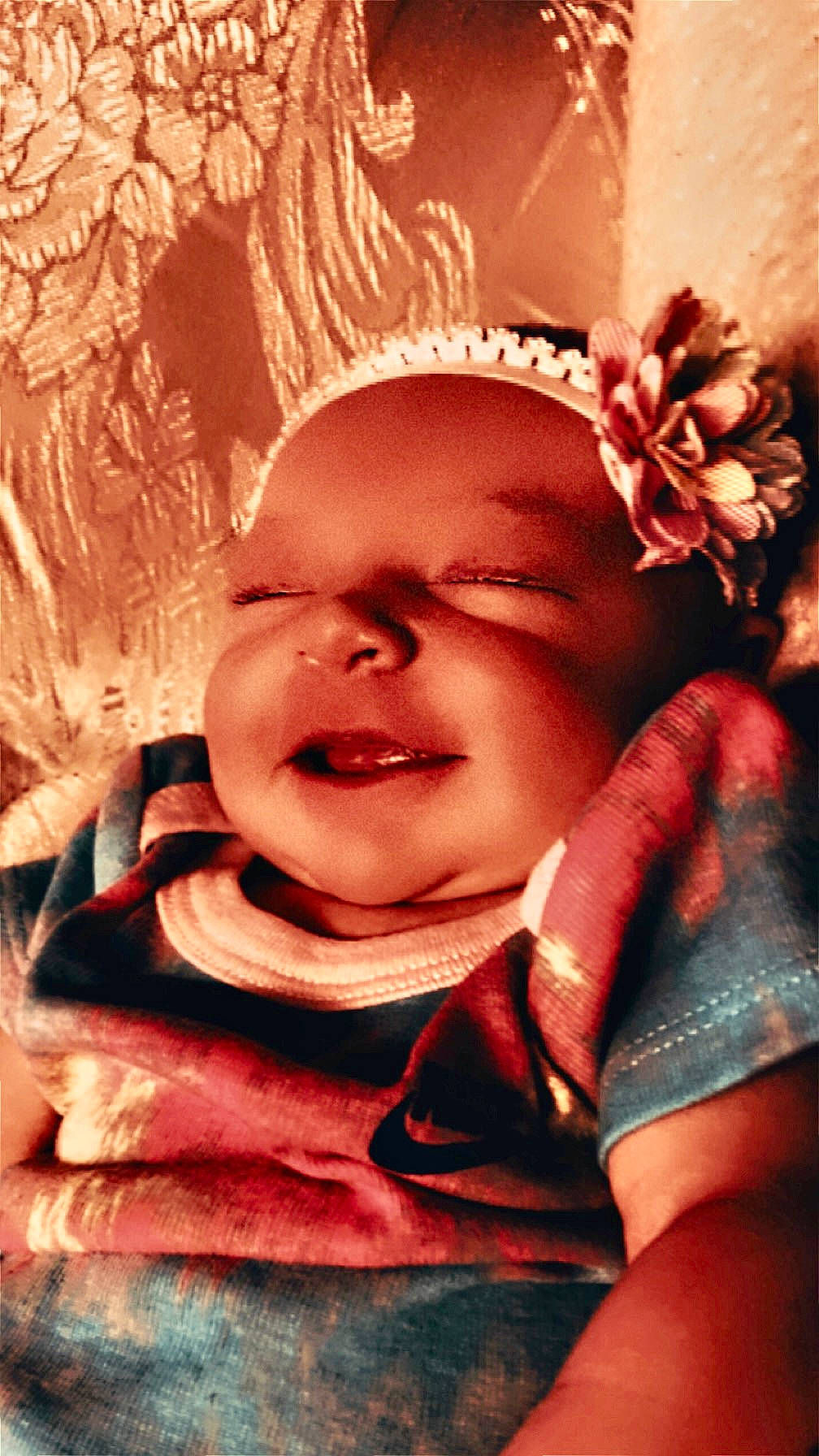 Shaniya is registered to the contest to win money with this photo: baby, cheek, eye, eyebrow, finger, forehead, gesture, hand, happy, headgear, human_body, lip, mouth, nose, person, pink, plant, skin, smile, textile