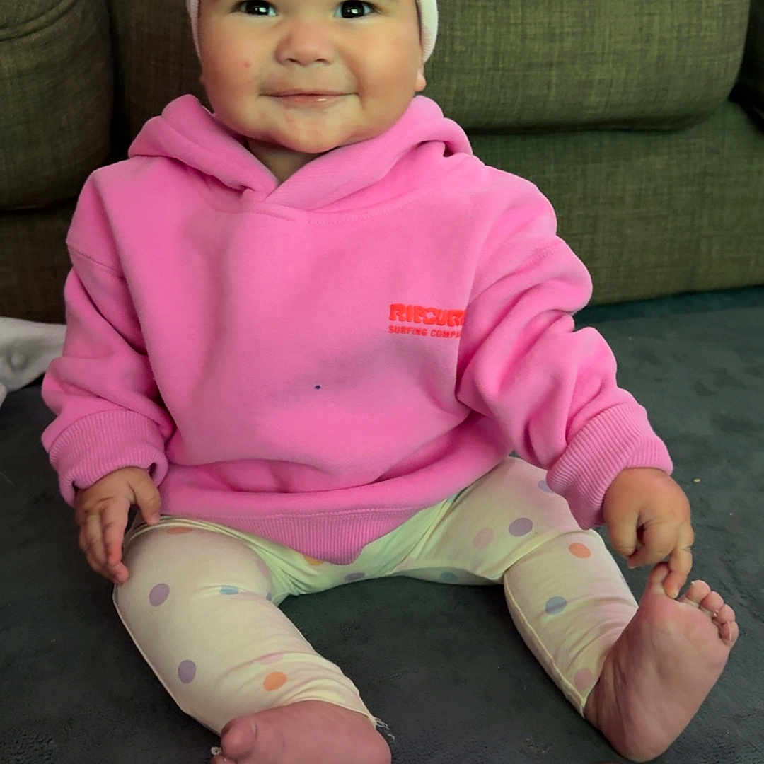 Zinayla is registered to the contest to win money with this photo: baby, bodypart, cap, clothing, couch, face, finger, furniture, hand, happy, hat, head, hoodie, knitwear, pants, person, photography, portrait, sitting, sweater