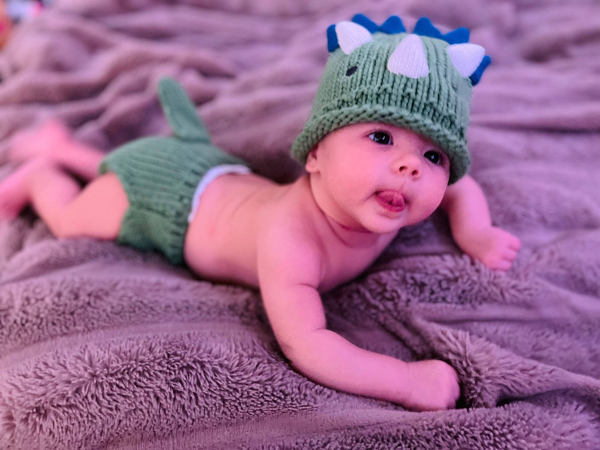 Jaxon is registered to the contest to win money with this photo: arm, baby, baby_toddler_clothing, beanie, cap, eye, grey, head, headgear, headwear, iris, knit_cap, linens, magenta, pattern, person, pink, purple, skin, sleeve