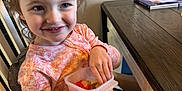 Saylor joined the competition — help win amazing prizes! toddler, child, smiling, pajamas, high_chair, snacking, fruit, indoor, wooden_table, books, happy, face, hand, seated, furniture, table, clothing, person, breakfast, casual