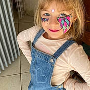 Luna participe au concours pour gagner de l'argent avec cette photo : blonde_hair, blue_eyes, boots, casual_clothing, child, confident_pose, cute, denim_dress, face_paint, furniture, girl, heart_pattern, home_interior, indoor, long_sleeve_shirt, playful, radiator, smile, tile_floor, young
