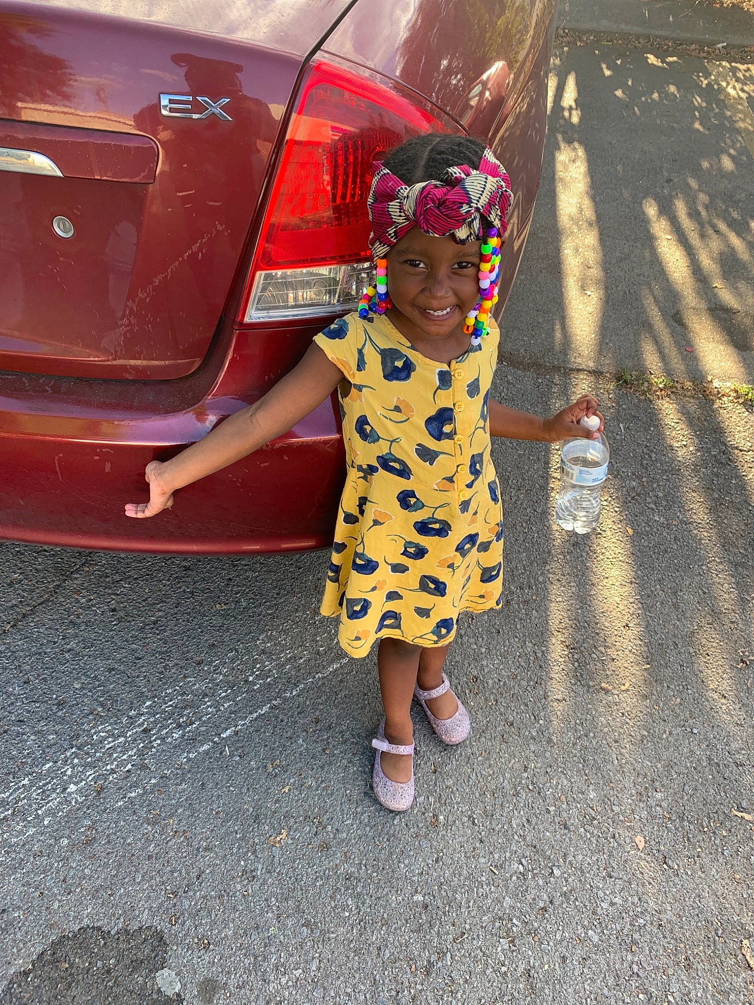 Aniylah is registered to the contest to win money with this photo: car, child, city_car, door, dress, footwear, fun, glasses, headwear, joy, person, photography, plant, shoe, street_fashion, summer, toddler, tree, vacation, vehicle