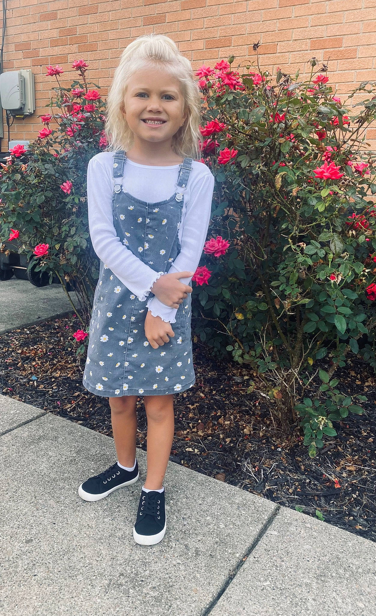 Harper is registered to the contest to win money with this photo: annual_plant, asphalt, baby_toddler_clothing, blond, day_dress, dress, electric_blue, flower, flowerpot, grass, joy, magenta, pattern, person, petal, pink, plant, red, sleeve, smile