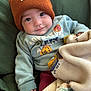 baby, child, beanie, hat, sweater, blanket, fleece, green, orange, cute, portrait, infant, cozy, warm, smile, hand, face, clothing, indoors, comfort