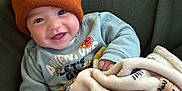 Elijah joined the competition — help win amazing prizes! baby, child, smiling, beanie, hat, blanket, cozy, sweater, cute, infant, happy, indoors, portrait, warm, soft, childwear, face, expression, comfort, seated