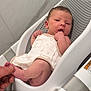 Alayna is registered to the contest to win money with this photo: baby, infant, newborn, baby_bath, baby_seat, skin, hand, foot, clothing, white, gray, person, indoor, toddler, cute, child, comfort, bathroom, parent, care