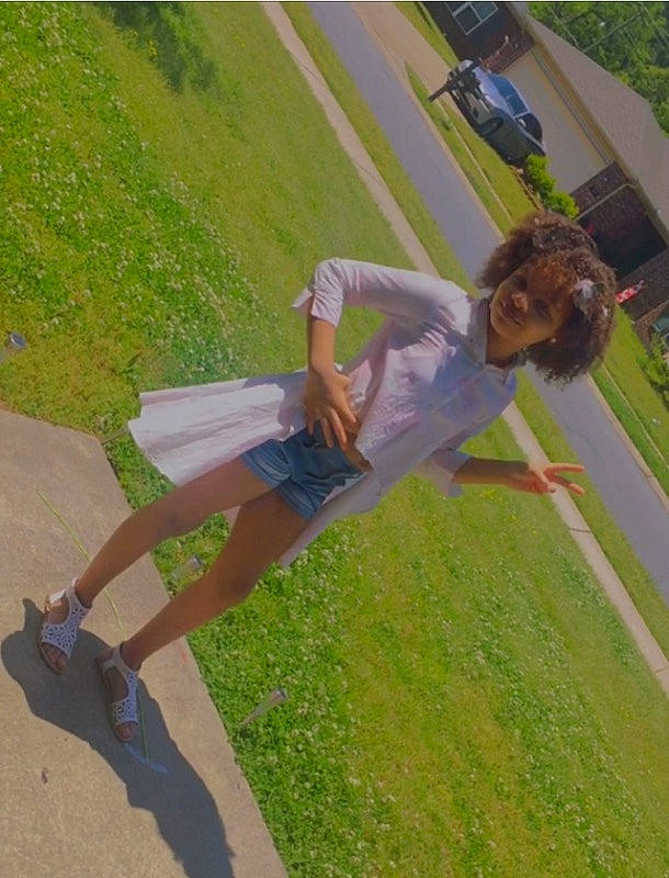 Alaynah joined the competition — help win amazing prizes! asphalt, fun, grass, happy, human_leg, knee, landscape, lawn, leisure, people_in_nature, person, plant, recreation, shadow, shorts, sidewalk, sneakers, sports, t_shirt, thigh