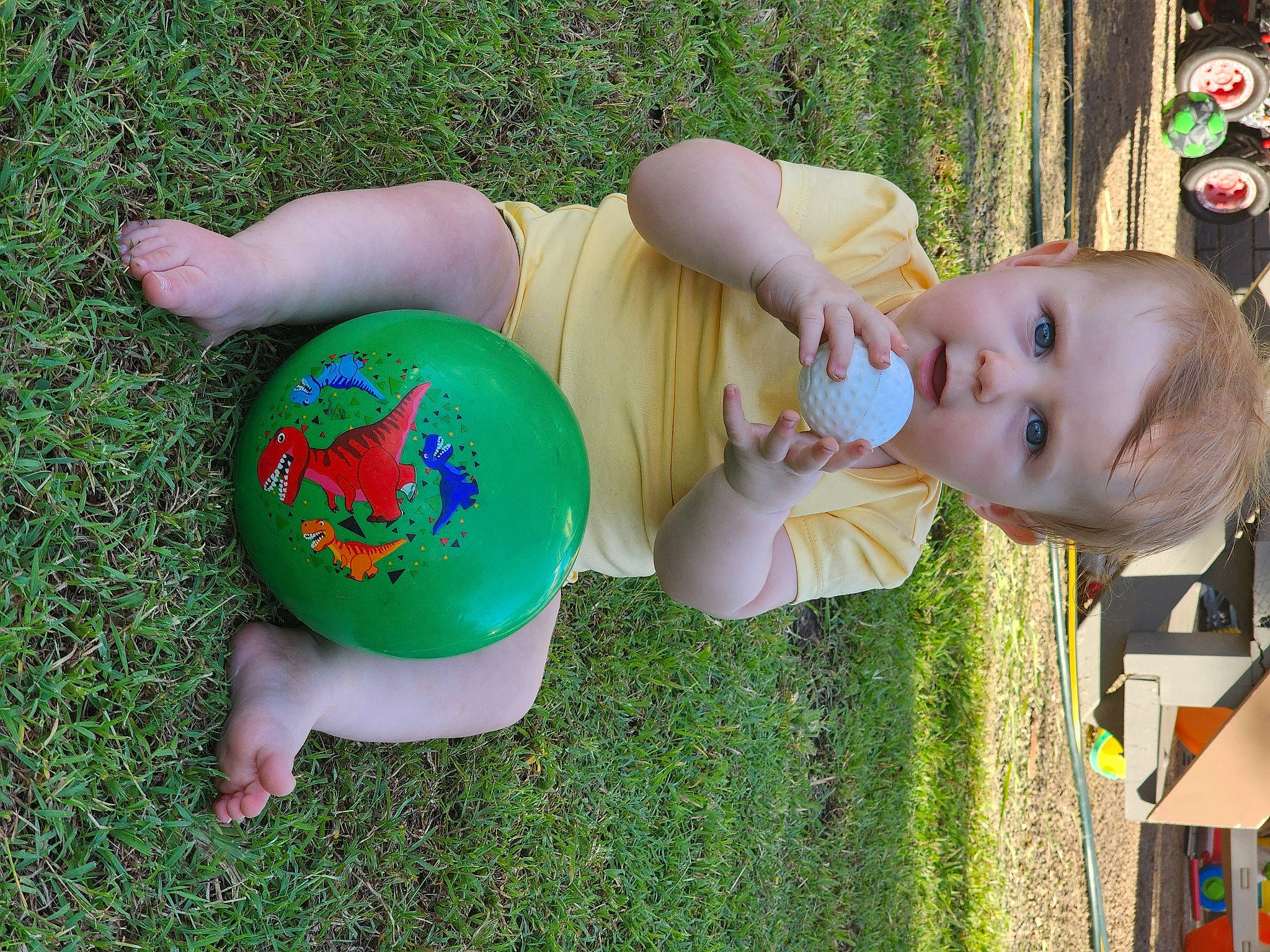 Nadia is registered to the contest to win money with this photo: baby, baby_toddler_clothing, child, facial_expression, fun, grass, green, happy, lawn, leisure, people_in_nature, person, plant, play, product, recreation, sitting, smile, t_shirt, toddler