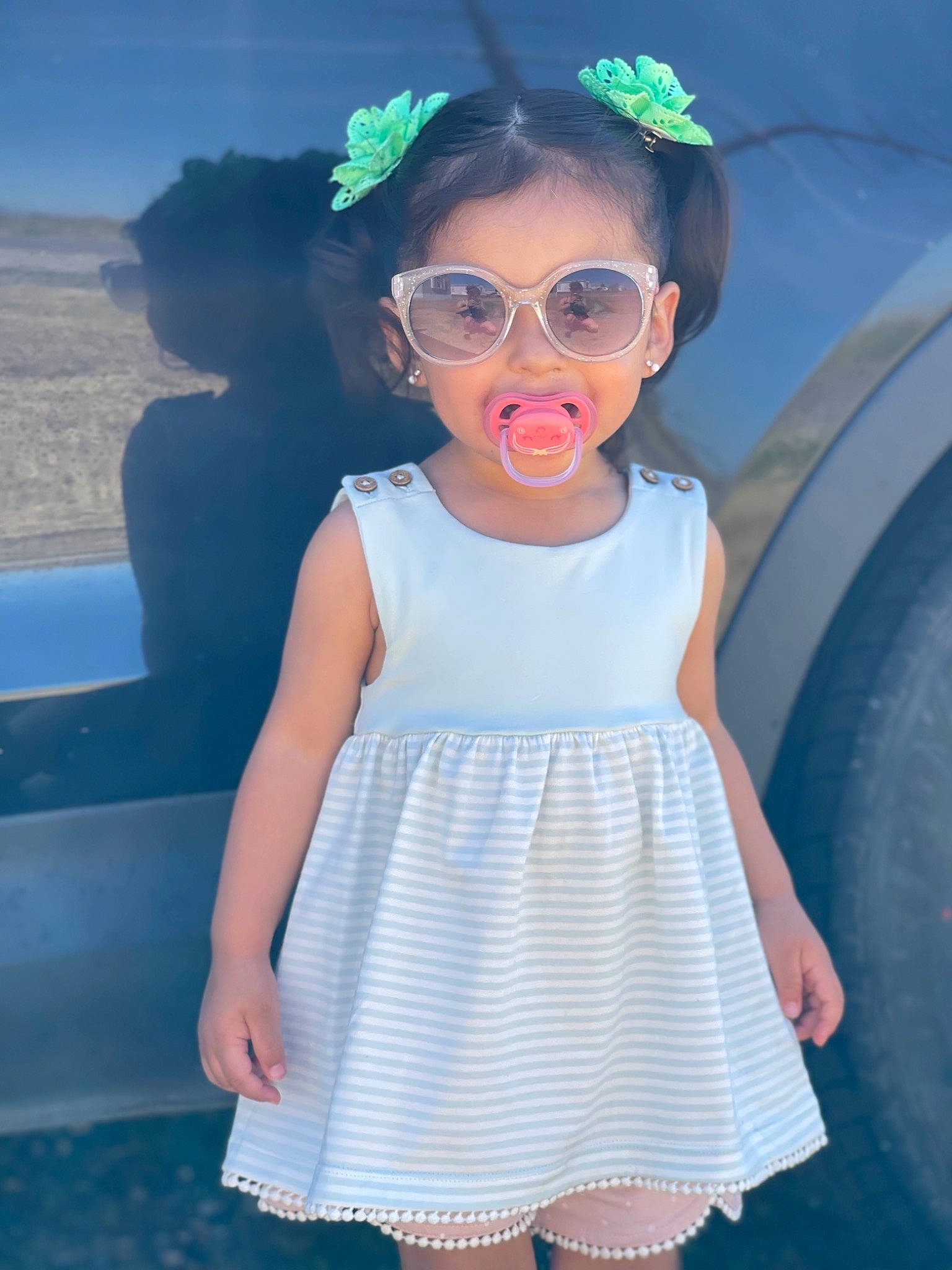 Laramie joined the competition — help win amazing prizes! azure, baby_toddler_clothing, blue, clothing, day_dress, dress, eyewear, glasses, goggles, hairstyle, happy, one_piece_garment, person, pink, skin, sleeve, standing, sunglasses, toddler, vision_care