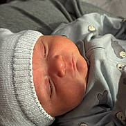 Nicholas joined the competition — help win amazing prizes! newborn, baby, sleeping, hat, clothing, infant, portrait, closeup, face, cozy, soft_light, cute, child, indoors, peaceful, person, baby_garment, knit_hat, baby_boy, resting