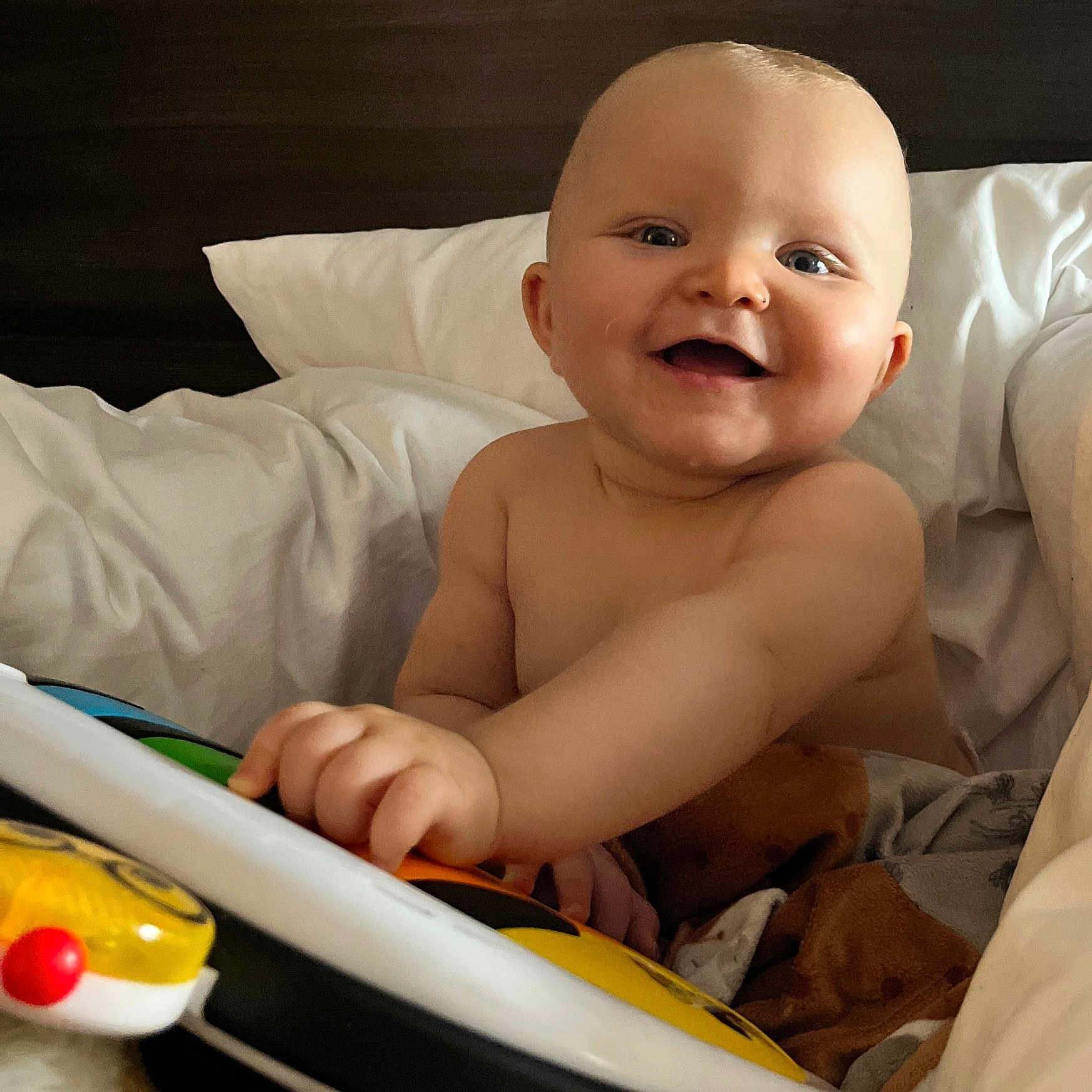 Christian-Levi joined the competition — help win amazing prizes! baby, bed, blanket, child, cozy, cute, expression, face, hand, happy, indoor, infant, person, piano, pillow, playful, skin, smiling, soft, toy