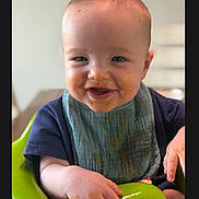 Archer joined the competition — help win amazing prizes! baby, child, smiling, messy_face, bib, high_chair, indoor, food, happy, portrait, infant, cute, young_child, feeding, seated, front_view, person, skin, clothing, face