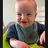 baby, child, smiling, messy_face, bib, high_chair, indoor, food, happy, portrait, infant, cute, young_child, feeding, seated, front_view, person, skin, clothing, face