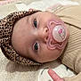 baby, beige, blanket, blue_eyes, child, closeup, clothing, cute, face, headband, human, infant, leopard_print, lying_down, newborn, pacifier, pink, portrait, sleepwear, soft_texture