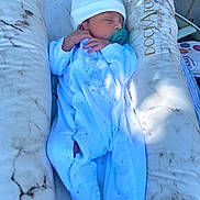 Lucca joined the competition — help win amazing prizes! baby, newborn, sleeping, pacifier, onesie, hat, cushion, dockatot, infant, resting, comfort, soft, marble_pattern, white_clothing, child, peaceful, portrait, indoor, baby_bed, relaxation
