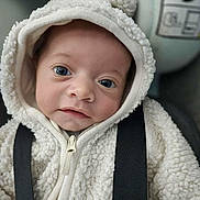 Eden a rejoint le concours — aidez-le/la à gagner de superbes lots ! baby, infant, hoodie, white, fluffy, pom_pom, face, blue_eyes, close_up, cute, young_child, straps, clothing, portrait, child, warm_clothing, indoors, soft_texture, looking_at_camera, adorable