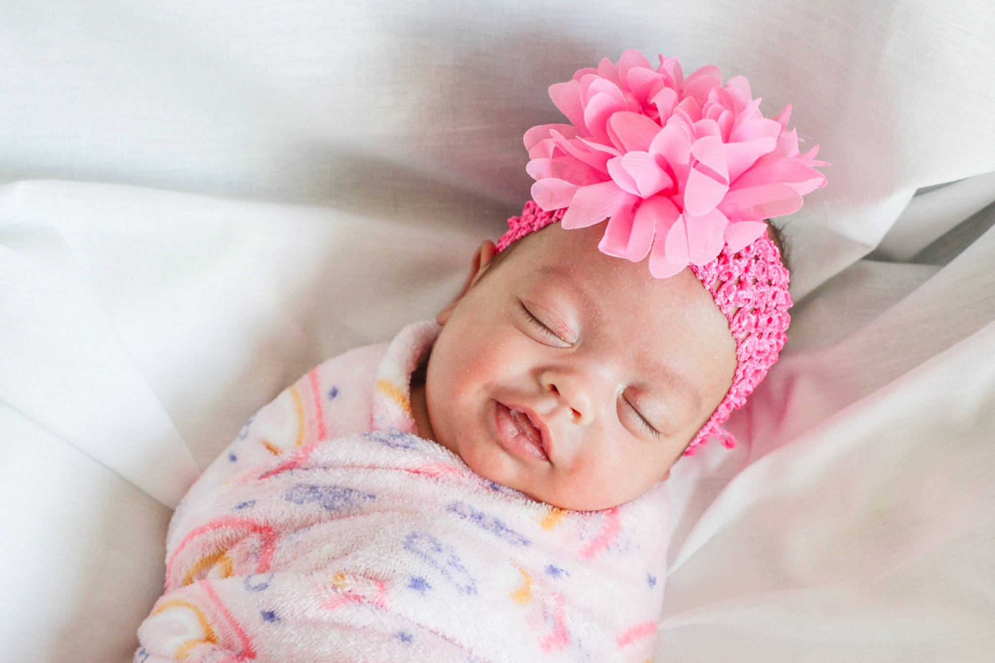 Jalyssa joined the competition — help win amazing prizes! baby, baby_sleeping, baby_toddler_clothing, child, comfort, flower, hair_accessory, happy, headband, headgear, headpiece, headwear, linens, lip, magenta, pattern, person, petal, pink, sleeve