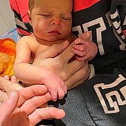 Remington is registered to the contest to win money with this photo: accessories, baby, blanket, bodypart, clothing, cushion, face, finger, hand, head, homedecor, jewelry, newborn, person, photography, portrait, quilt, ring, sleeping, t_shirt