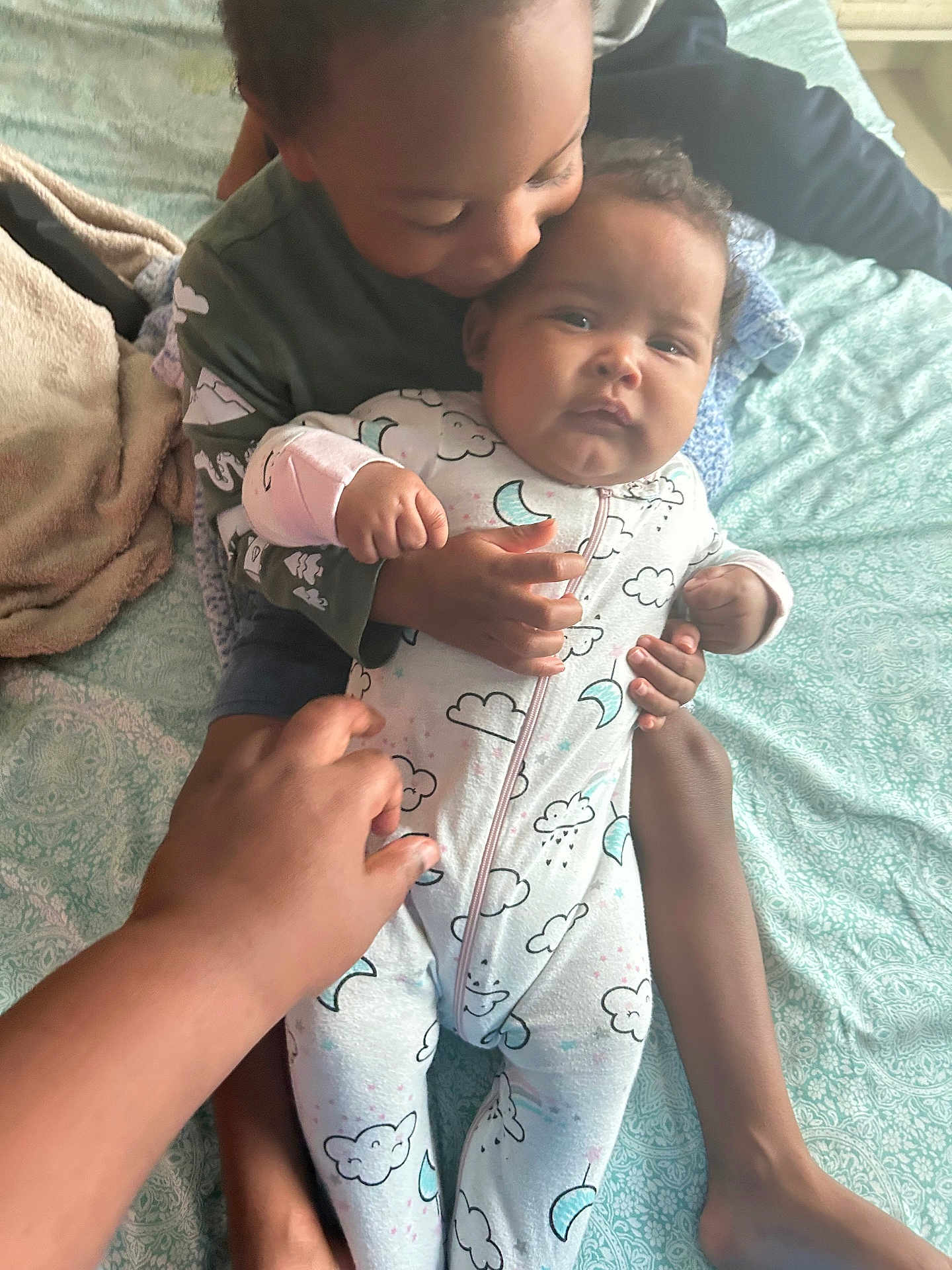 Adrian joined the competition — help win amazing prizes! baby, child, toddler, onesie, bed, blanket, hand, foot, kiss, cuddle, family, playful, love, pattern, clothing, indoor, skin, holding, smiling, affection