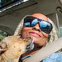 Pj Beckum joined the competition — help win amazing prizes! car_interior, casual, closeup, curly_hair, daylight, dog, happy, leash, licking, outdoor_view, pet, portrait, reflection, seatbelt, selfie, smile, sunglasses, sunroof, vehicle, woman