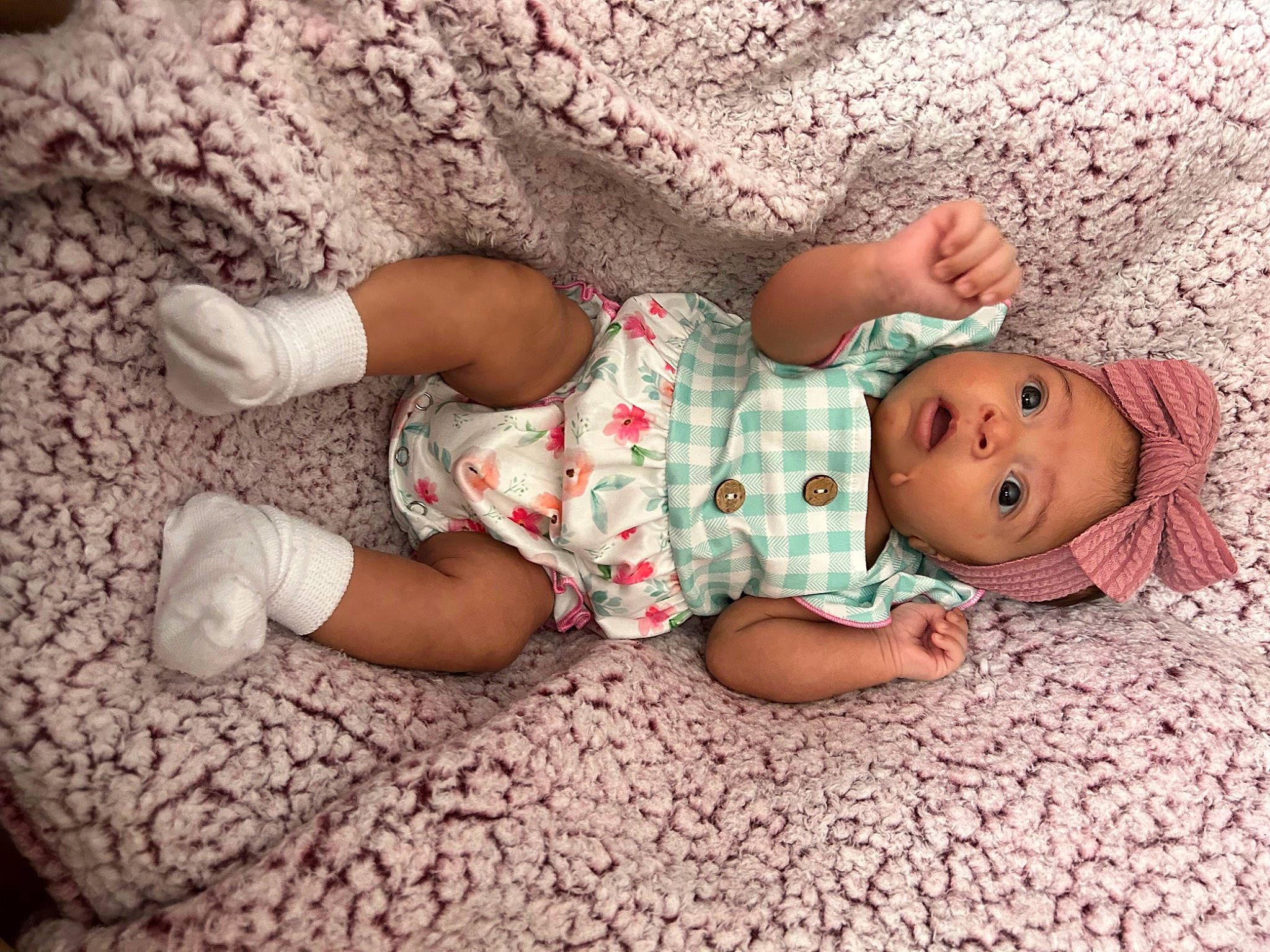 Talia joined the competition — help win amazing prizes! baby, baby_sleeping, baby_toddler_clothing, child, comfort, dress, finger, flooring, foot, headwear, human_body, human_leg, leg, linens, pattern, person, skin, sleeve, sock, surprise