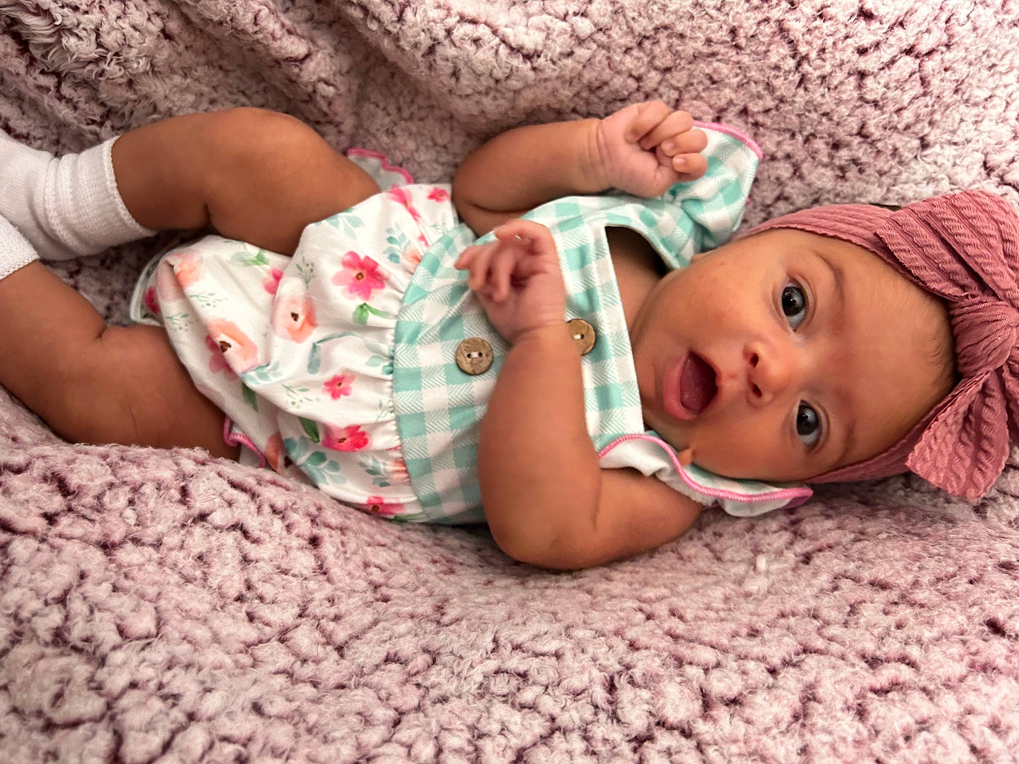 Talia joined the competition — help win amazing prizes! arm, baby, baby_toddler_clothing, beauty, child, comfort, finger, flooring, grass, hand, headwear, linens, lip, mouth, nail, nose, person, pink, skin, surprise