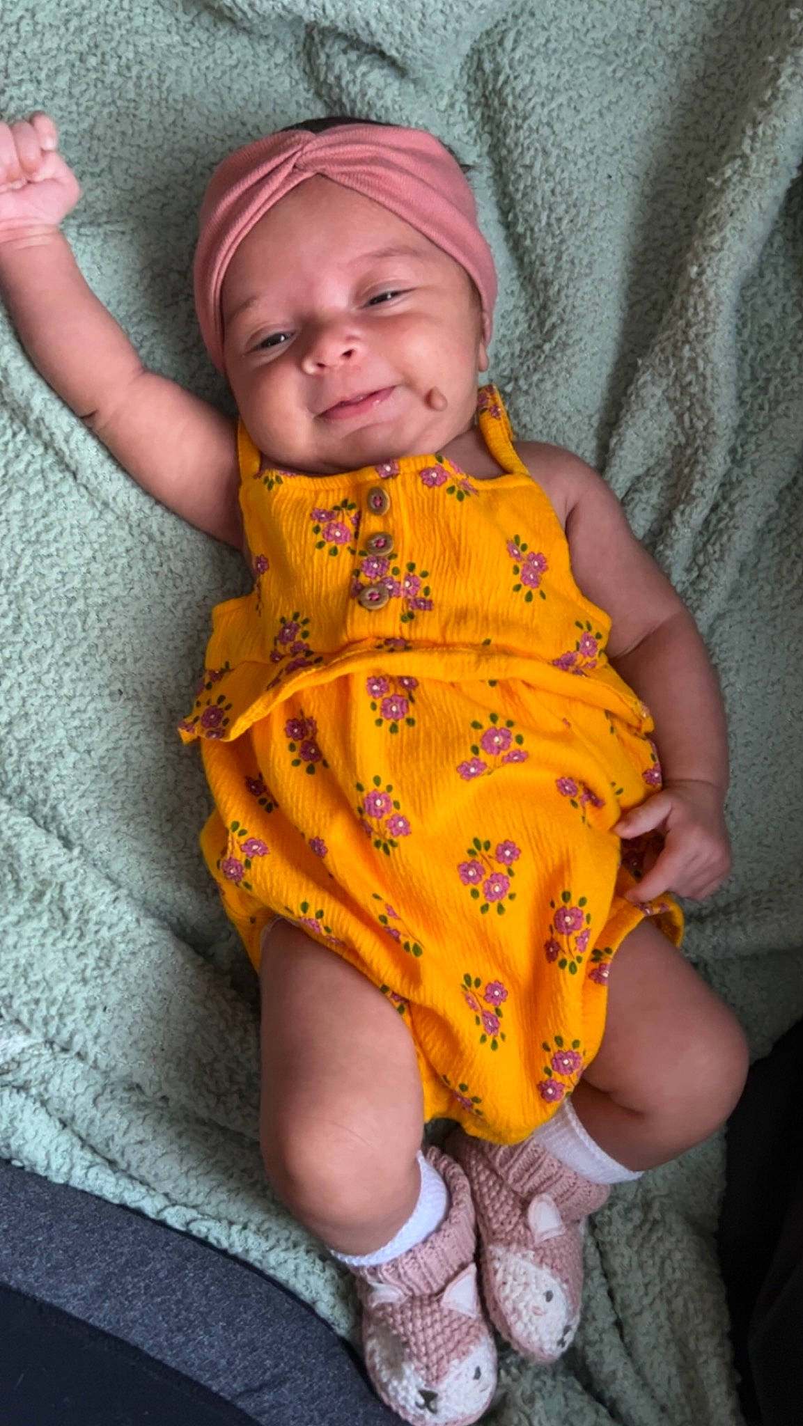 Talia joined the competition — help win amazing prizes! baby, baby_toddler_clothing, cheek, child, comfort, eye, facial_expression, finger, happy, head, headwear, linens, nose, orange, pattern, person, sitting, skin, sleeve, smile