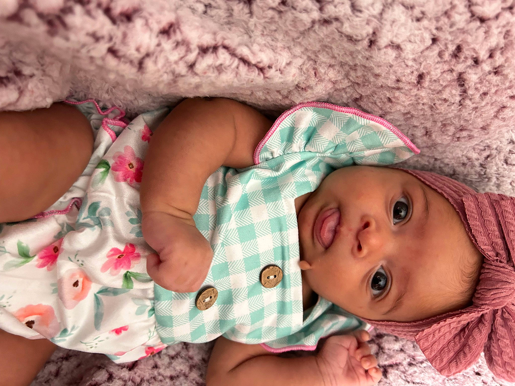 Talia is registered to the contest to win money with this photo: arm, baby, baby_toddler_clothing, cheek, child, comfort, eye, face, finger, hand, headwear, human_body, lip, mouth, nose, person, pink, skin, sleeve, textile