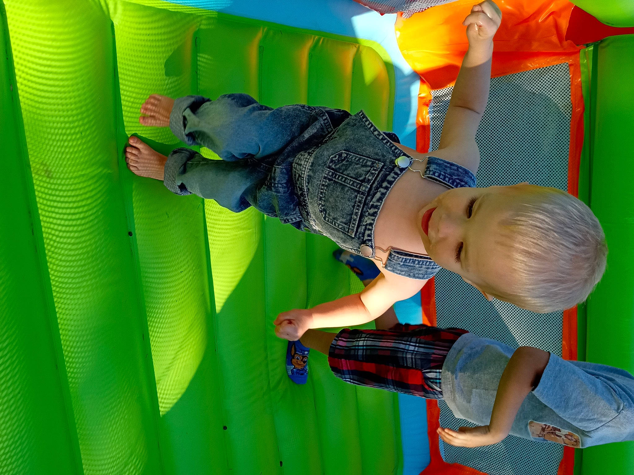 Orion is registered to the contest to win money with this photo: baby, baby_toddler_clothing, bounce_house, child, chute, fun, green, happy, leisure, magenta, outdoor_play_equipment, pattern, person, play, playground, recreation, room, t_shirt, toddler