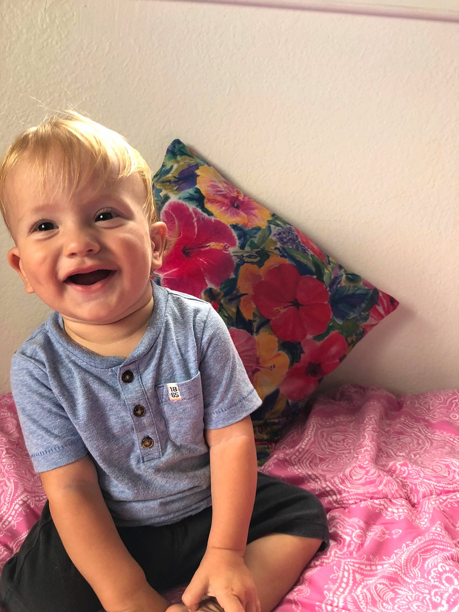 Kj  is registered to the contest to win money with this photo: arm, child, day, eye, girl, hair, human_hair_color, infant, pattern, person, pink, sitting, skin, smile, textile, toddler