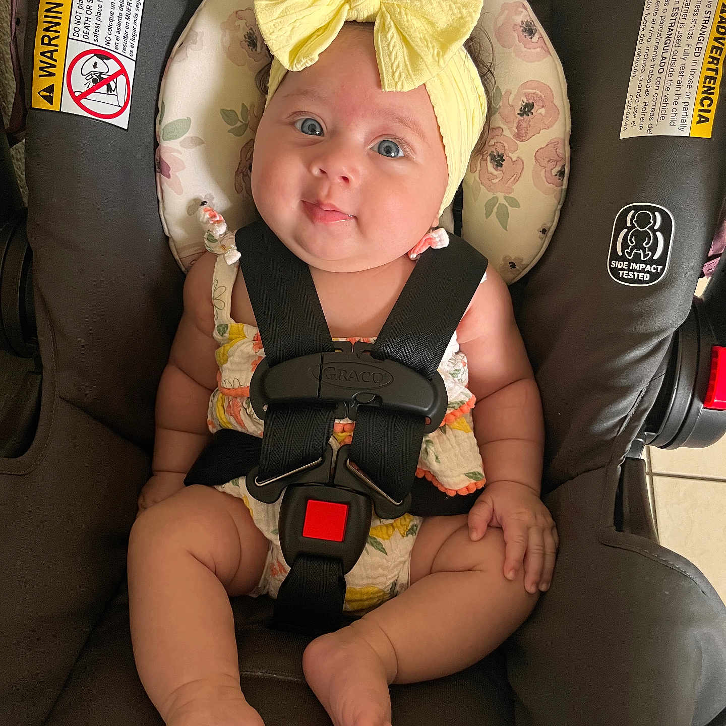 Omi joined the competition — help win amazing prizes! baby, blue_eyes, car_seat, child, clothing, cute, fabric, face, feet, floor_tiles, hands, headband, indoor, infant, legs, safety, sitting, skin, straps, yellow_bow