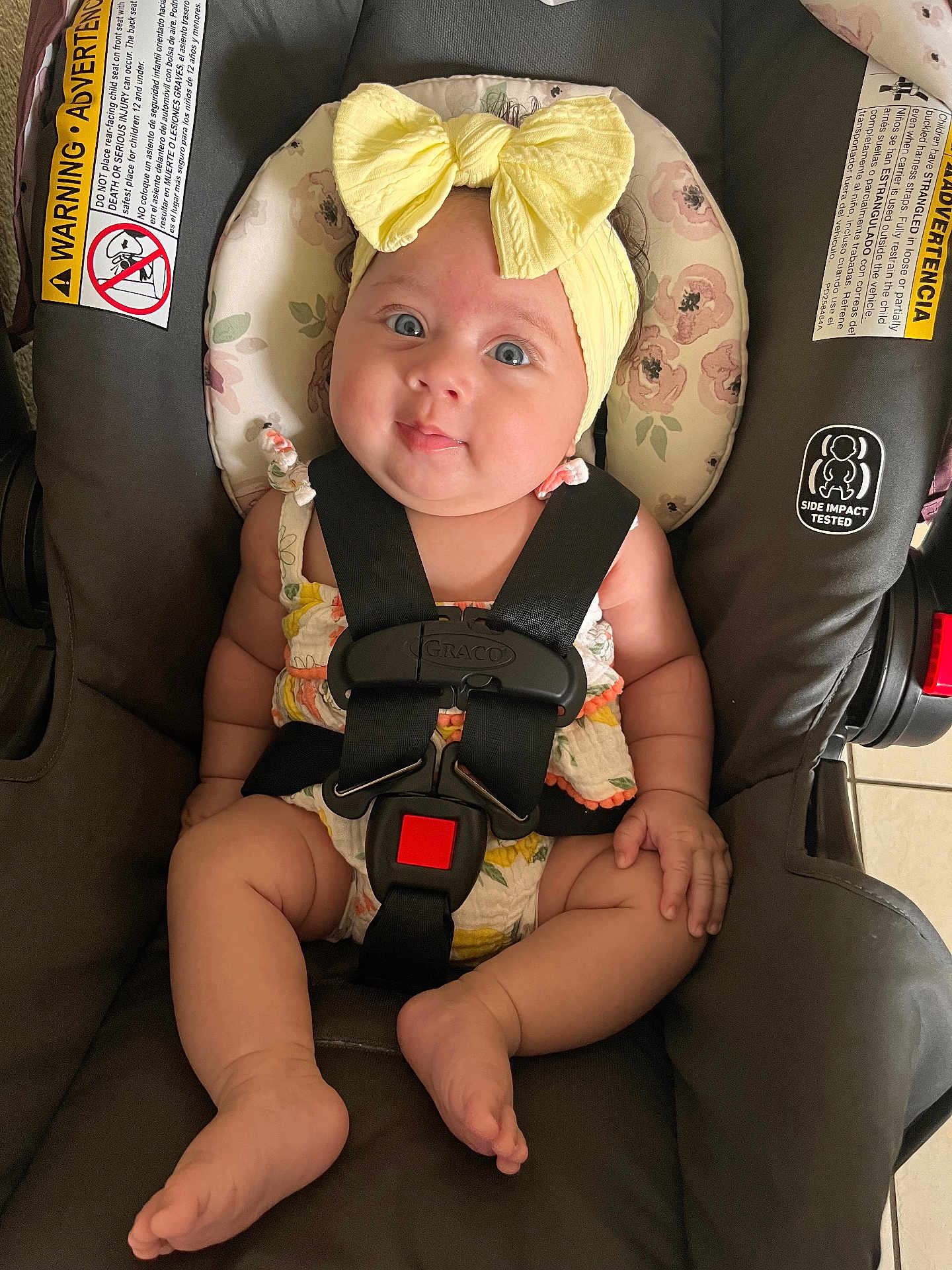 Omi joined the competition — help win amazing prizes! baby, blue_eyes, car_seat, child, clothing, cute, fabric, face, feet, floor_tiles, hands, headband, indoor, infant, legs, safety, sitting, skin, straps, yellow_bow
