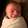 newborn, baby, sleeping, infant, portrait, face, closed_eyes, swaddled, blanket, cozy, indoors, warm_lighting, peaceful, resting, head, skin, young_child, photography, close_up, burrito