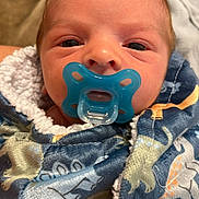 Julian joined the competition — help win amazing prizes! newborn, baby, infant, child, face, portrait, pacifier, blanket, bundled, swaddled, blue, colorful, sleeping, indoors, close_up, eyes, head, cozy, cuddly, family