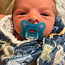 newborn, baby, infant, child, face, portrait, pacifier, blanket, bundled, swaddled, blue, colorful, sleeping, indoors, close_up, eyes, head, cozy, cuddly, family