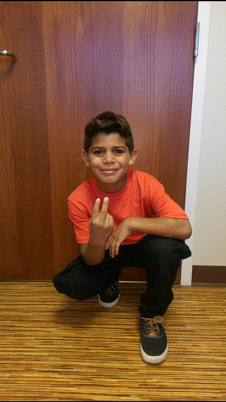 Oscar is registered to the contest to win money with this photo: arm, child, floor, flooring, hardwood, joy, person, shoe, sitting, standing, toddler, wood