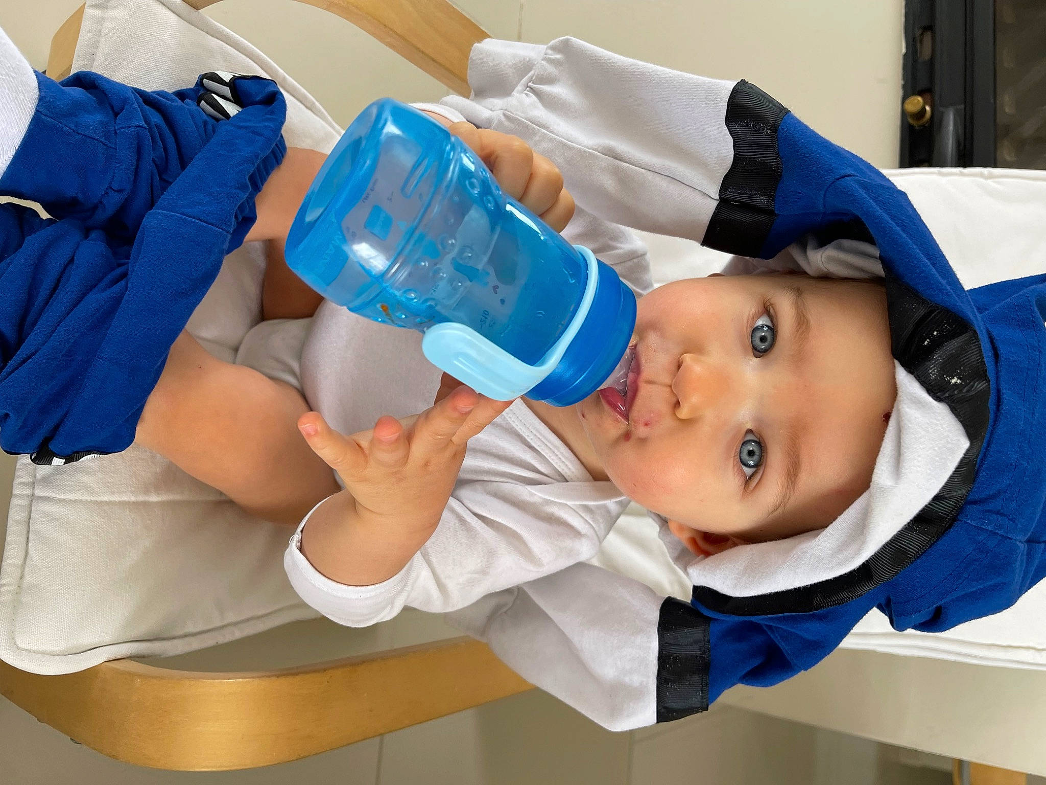 Tao participe au concours pour gagner de l'argent avec cette photo : baby, baby_products, baby_toddler_clothing, cap, child, drinkware, electric_blue, hat, headwear, health_care, human_leg, knee, person, plastic, plastic_bottle, room, service, smile, toddler, water