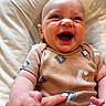 Connor joined the competition — help win amazing prizes! baby, smiling, infant, onesie, patterned_clothing, cushion, hand, happy, skin, face, child, lying_down, cute, indoors, closeup, human, small_person, soft_texture, joy, expression