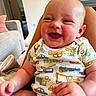 Connor joined the competition — help win amazing prizes! baby, infant, smiling, laughing, onesie, clothing, hand, indoor, living_room, sofa, pillow, person, child, cute, happy, skin, furniture, head, seated, home