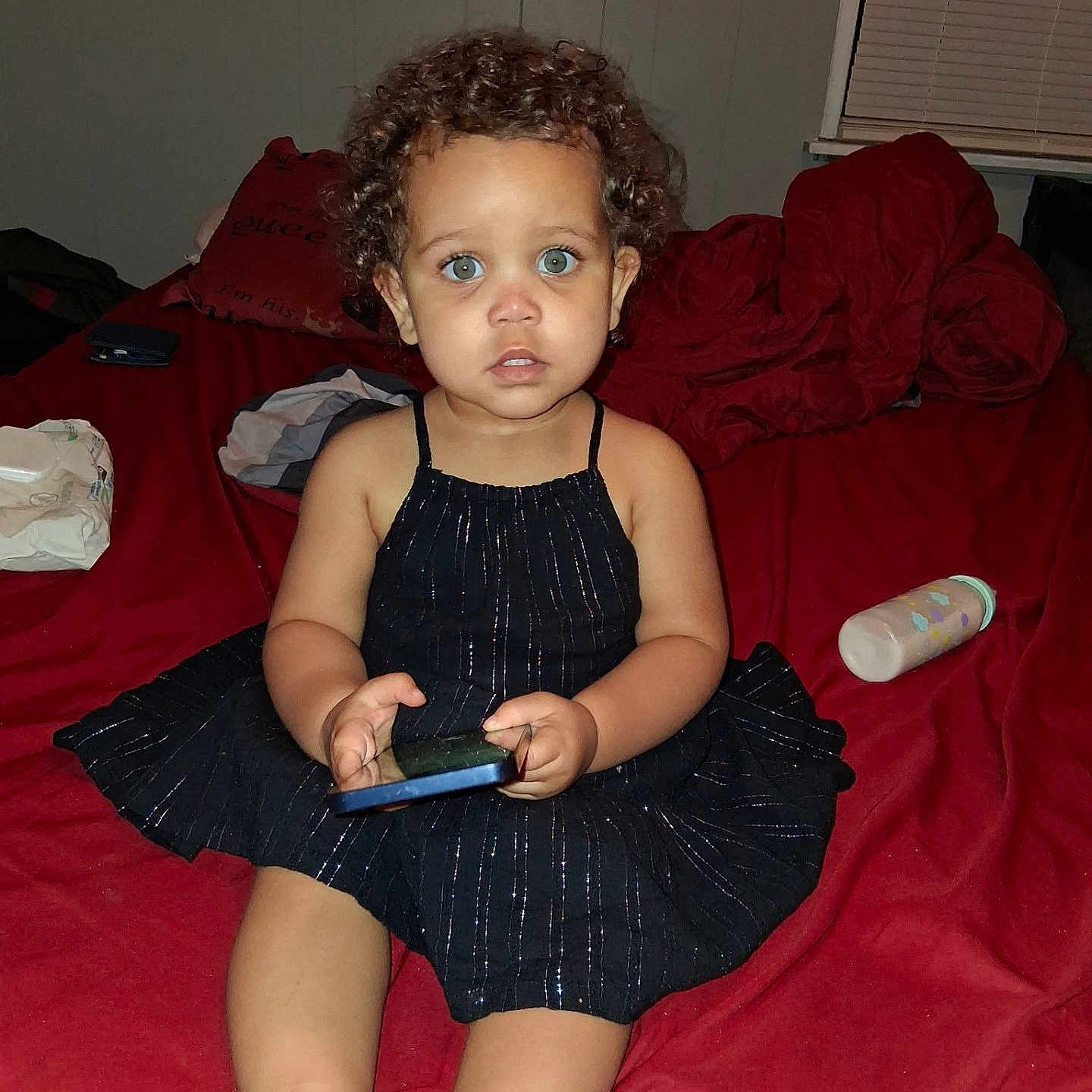 Khloe White is registered to the contest to win money with this photo: accessories, bag, bed, child, clothing, couch, dress, electronics, face, female, furniture, girl, handbag, head, indoors, person, phone, photography, portrait, sitting