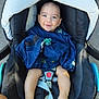 Hayden a rejoint le concours — aidez-le/la à gagner de superbes lots ! baby, child, car_seat, blue_clothing, pacifier, barefoot, smiling, infant, safety_harness, outdoor, person, cute, happy, seat, foot, head, face, baby_clothes, transport, daylight