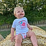 child, toddler, smiling, outdoor, hay_bale, summer, greenery, blue_eyes, blond_hair, shorts, tshirt, cute, happy, nature, sunlight, grass, playful, baby, portrait, daylight