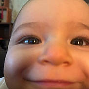 Romeo is registered to the contest to win money with this photo: baby, close_up, face, smile, cheeks, eyes, infant, cute, child, portrait, skin, head, happy, indoors, expression, young, person, chubby, nose, mouth